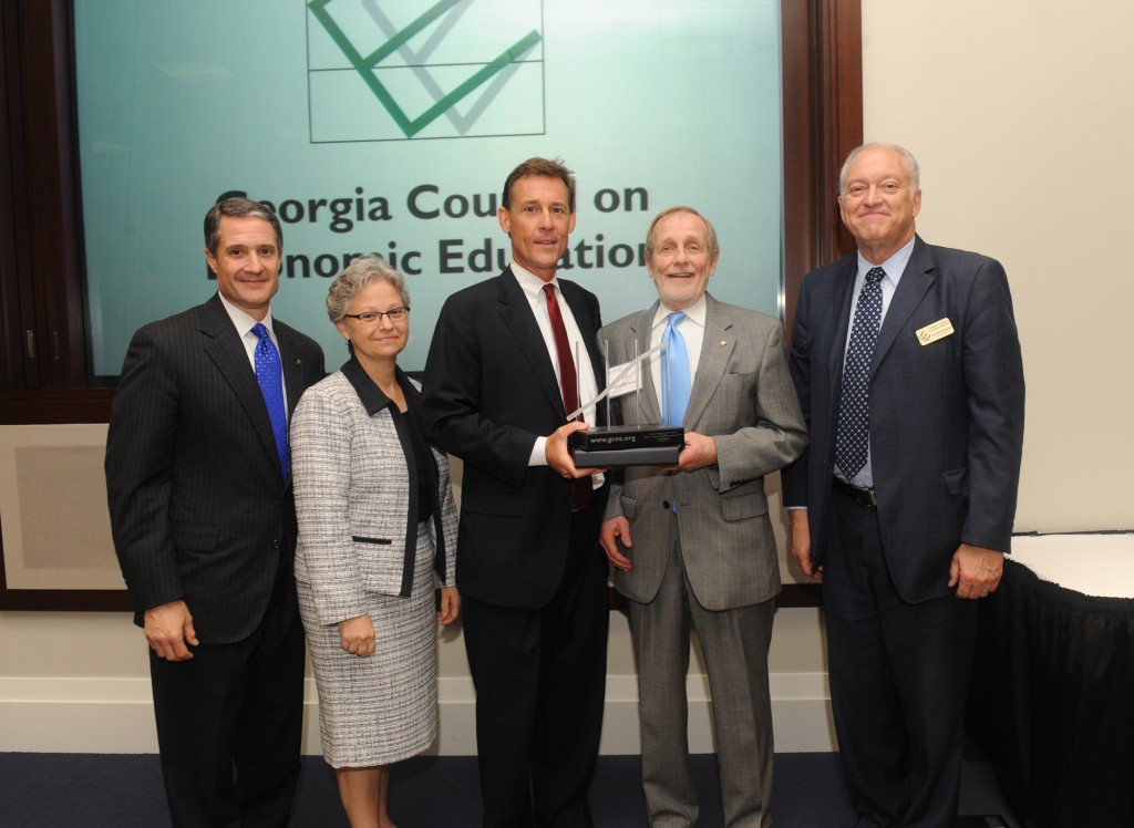 Presenting Neil Shorthouse with his award from left to right: Gary Price, Managing Partner, PricewaterhouseCoopers (and the GCEE outgoing Chair), Marie Gooding, First VP & COO, Federal Reserve Bank of Atlanta (GCEE incoming chair), Russ Hardin, President The Robert W. Woodruff Foundation, Inc., Neil Shorthouse and David Martin, GCEE Executive Director.